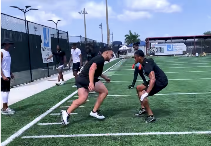 Defensive back performing the kick slide during press coverage training