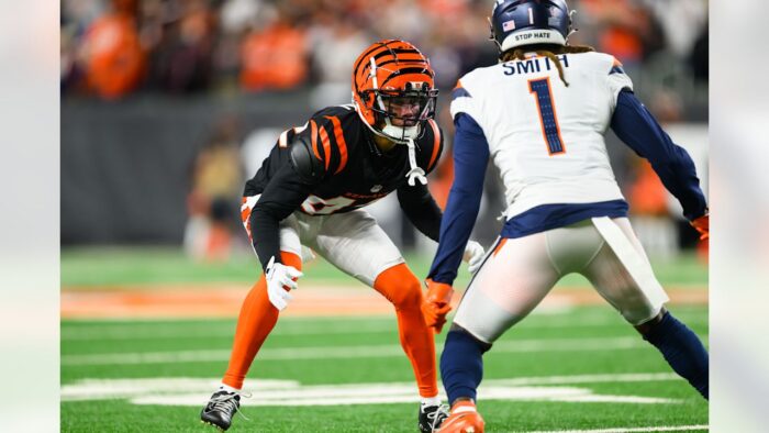 Defensive back covering a slant route in press man coverage